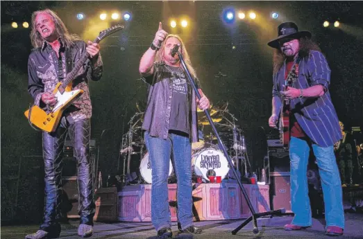  ?? JOHN RUSSELL/AP ?? Lynyrd Skynyrd lead singer Johnny Van Zant (center) and guitarists Rickey Medlocke (left) and Gary Rossington perform in Nashville, Tennessee, in 2005.