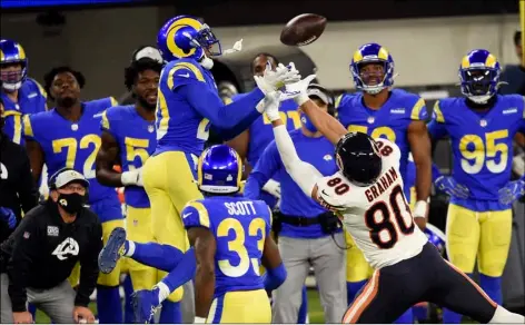  ?? AP Photo/Kelvin Kuo ?? Los Angeles Rams cornerback Jalen Ramsey (left) intercepts a pass intended for Chicago Bears tight end Jimmy Graham (80) during the second half of an NFL football game on Monday in Inglewood, Calif.