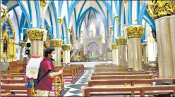  ?? PTI PHOTO ?? A worker sprays disinfecta­nt at Bengaluru’s St Basilica Church. n