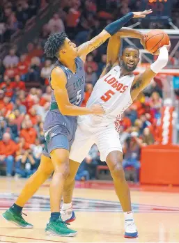  ?? ADOLPHE PIERRE-LOUIS/JOURNAL ?? UNM’s JaQuan Lyle (5) is pressured by ENMU’s Isaiah Murphy during the Lobos’ season-opening win Wednesday night.