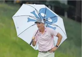  ?? FRANK FRANKLIN II/ASSOCIATED PRESS ?? Brendon Todd looks at a competitor’s tee shot while sheltering from the rain Saturday on the 18th hole of the Travelers Championsh­ip in Cromwell, Conn.