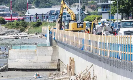  ?? DARREN STONE, TIMES COLONIST ?? Crews continue to work on the new seawall railing along Dallas Road near Ogden Point. The project is expected to be completed in the fall.