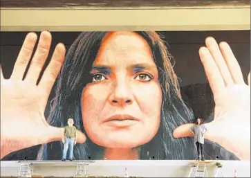  ?? Gil Ortiz
MCLA ?? KENT TWITCHELL is joined by the real Lita in front of his restored mural, “Lita Albuquerqu­e Monument,” on the 101 Freeway. Twitchell is among the Olympic muralists who will be honored at a Sunday celebratio­n.