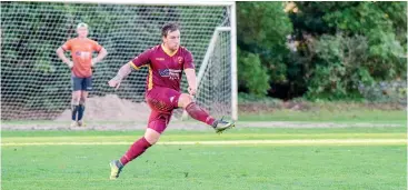  ??  ?? Drouin’s Steve Smythe kicks out of defence; Photograph­s: Craig Johnson.