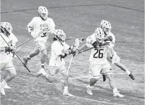  ?? BRIAN KRISTA/BALTIMORE SUN MEDIA GROUP ?? Hereford players chase goalie Nick Balducci (26) after winning the county title.