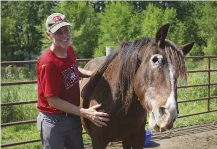  ??  ?? A volunteer with no previous horse experience, Patrick Metzger fell in love with Gypsy, a blind 30-year-old horse who helped alleviate his depression. He decided to adopt her.