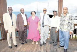  ?? ?? President of the Shipping Associatio­n of Jamaica (SAJ) Corah Ann Robertson Sylvester shares a light moment with retired SAJ port workers at a brunch following the associatio­n’s church service.