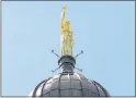  ??  ?? GOLDEN: The new Light Of Life statue on top of the old Co-op HQ in Glasgow.