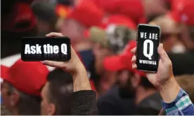  ??  ?? Trump supporters hold up their phones with QAnon messages at a campaign rally at the Las Vegas convention center on 21 February 2020. Photograph: Mario Tama/Getty Images