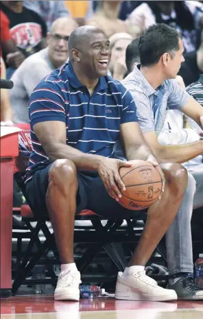  ?? JOHN LOCHER / AP ?? Magic Johnson watches the Los Angeles Lakers defeat the Portland Trail Blazers in Monday’s NBA summer-league clash in Las Vegas.