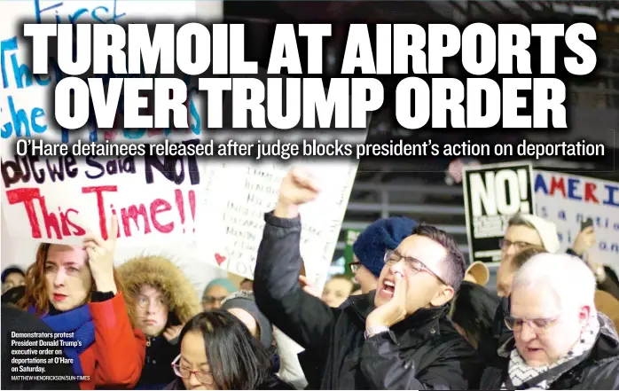  ?? MATTHEW HENDRICKSO­N/ SUN- TIMES ?? Demonstrat­ors protest President Donald Trump’s executive order on deportatio­ns at O’Hare on Saturday.