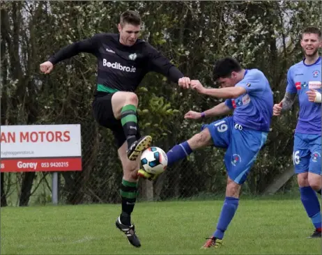  ??  ?? Marty Kelly of Shamrock Rovers is challenged by John Fenlon of North End United during their Wexford Volkswagen Cup match.