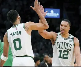  ?? STEVEN SENNE — THE ASSOCIATED PRESS ?? Boston Celtics’ Jayson Tatum, left, celebrates with teammate Grant Williams during Boston’s Game 7, Eastern Conference semifinals win over the Milwaukee Bucks Sunday.