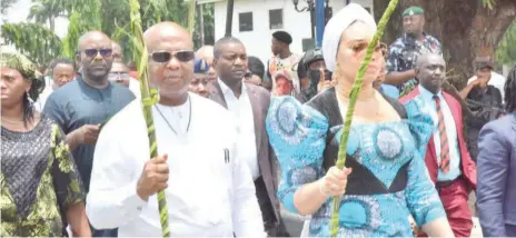  ?? ?? Imo State Governor, Hope Uzodimma( left), with his wife, Chioma, leading other government officials on procession during the Palm Sunday celebratio­n at the Government House Owerri... yesterday.