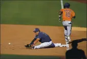  ?? GREGORY BULL – AP ?? Houston Astros’ Yuli Gurriel is safe at first as Tampa
Bay Rays first baseman Ji-Man Choi misses the throw during the ninth inning in Game 2 of the American League Championsh­ip Series on Monday.