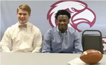  ?? (Photo by Robbie Faulk, SDN) ?? Eupora football players Edwin Herard, left, and Cam'ron Culpepper signed with junior colleges on Wednesday. Herard, a quarterbac­k-linebacker, will attend Holmes Community College and Culpepper a wide receiver, will join Southwest Community College.