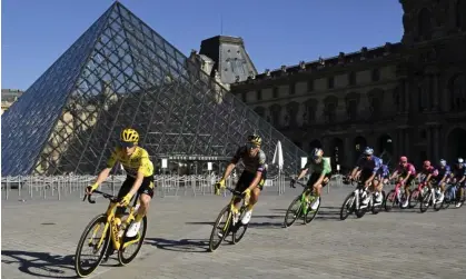  ?? Photograph: Bertrand Guay/AP ?? Jonas Vingegaard (left) heads past the Louvre to Tour de France victory last year but who will be wearing the yellow jersey into Paris on Sunday 23 July?