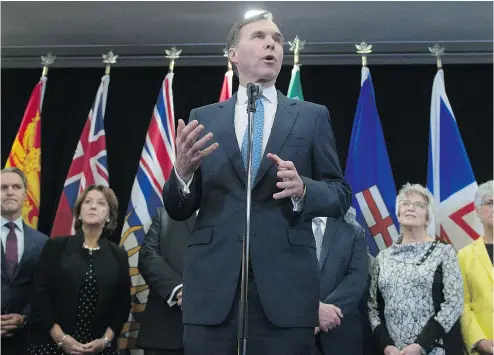  ?? SEAN KILPATRICK / THE CANADIAN PRESS ?? Federal Finance Minister Bill Morneau holds a news conference after meeting with his provincial counterpar­ts in Ottawa on Monday, where a deal was struck over the federal-provincial split on marijuana taxes.