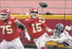  ?? Charlie Riedel / Associated Press ?? Patrick Mahomes (15) and the Chiefs clinched the top seed in the AFC and a first-round bye with their club-record 10th straight win.