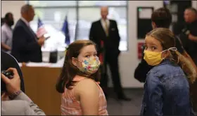  ?? (AP/Jeffrey Collins) ?? Two students at Camden Elementary School in Camden, S.C., attend an event in September in which Gov. Henry McMaster talked about steps the school was taking to prevent coronaviru­s infections.