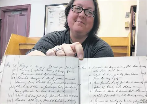  ?? CARLA ALLEN ?? Yarmouth County Museum and Archives archivist Lisette Gaudet holds a sample of century-old cursive writing that participan­ts will learn how to decipher during a new online genealogy workshop series starting Jan. 23.