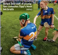  ?? INPHO ?? Down and out: A young fan consoles Tipp’s Noel McGrath