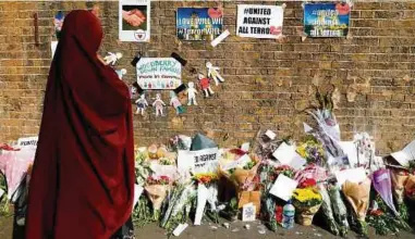  ?? AFP PIC ?? A woman placing flowers near the area of the
Finsbury Park attack in London last year.