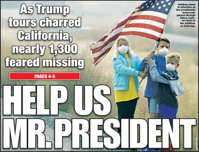  ??  ?? Children stand at attention as the presidenti­al motorcade passes through Chico, Calif., en route to the wildfires on Saturday.