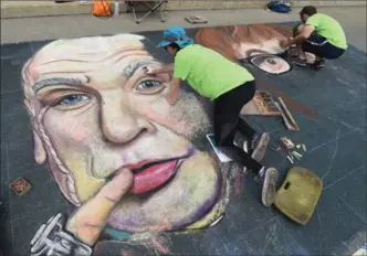  ?? PETER LEE, RECORD STAFF ?? Lori Hughes, left, of Columbus, Ohio, and Erik Greenawalt, right, of Pittsburgh, Pa., work together creating chalk art on the pavement of Main Street in Galt, of Mike Myers characters Dr. Evil, left, and Austin Powers, right, at the Internatio­nal...