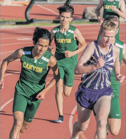  ??  ?? Canyon distance runner Ethan Danforth (left) makes a move late in the 3200 race at a meet on Thursday.