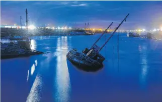  ?? PHOTOS: JAHI CHIKWENDIU/WASHINGTON POST ?? An old fishing boat rests in the Stanley Harbour in Stanley, Falkland Islands. Oil exploratio­n has begun around the islands, but fishing remains the country’s main economic contributo­r.