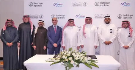  ?? ?? Waleed Mashak, general manager at Boehringer Ingelheim, and Sheikh Yaser Al-Naghi, chairman of Alpha Pharma, with other officials at the signing ceremony in Jeddah.