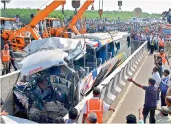  ?? DC ?? Police and rescue officials lift the Diwakar Travels bus which plunged into a river near Moolapadu in Penuganchi­proli mandal in Krishna District. —