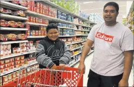  ?? Grace Garces Bordallo The Associated Press ?? Tyrone Quinata, 23, and his nephew Rayden Gofigan, 11, shop for batteries and other necessitie­s Thursday in Tamuning, Guam. An intensifyi­ng tropical storm in the Pacific is bearing down on Micronesia and could threaten the U.S. territory of Guam in the coming days.