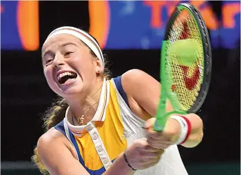  ??  ?? Jelena Ostapenko of Latvia hits a return to Karolina Pliskova of the Czech Republic during their WTA Finals tennis tournament round robin match in Singapore on Thursday. Ostapenko won 6-3, 6-1. — AFP