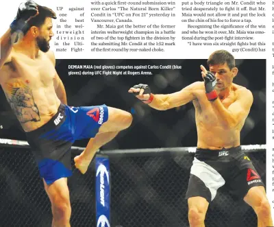  ??  ?? DEMIAN MAIA (red gloves) competes against Carlos Condit (blue gloves) during UFC Fight Night at Rogers Arena.