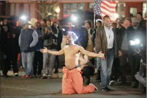  ?? PICTURE: REUTERS ?? OUTRAGED: A protester shouts at police as he blocks traffic before being arrested in Ferguson, Missouri, where unarmed black teen Michael Brown, 18, was shot and killed.