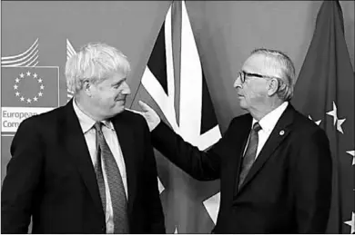  ??  ?? European Commission President Jean-Claude Juncker and Britain’s Prime Minister Boris Johnson react during a news conference after agreeing on the Brexit deal. (Photo: The Business Times)