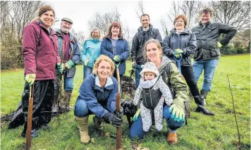  ??  ?? Front, Gillian Kenny and Jess David with Daisy (7 months) with members of the Friends of Moorland group who have been planting trees in the field behind Baskervill­es Gym, Moorlands Park, Englishcom­be Lane, Bath Picture: Artur Lesniak