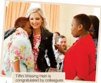  ??  ?? Tiffini Wissing Hein is congratula­ted by colleagues after being named Woman of the Future 2017.