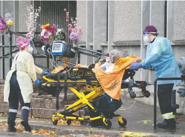  ?? FRANK GUNN / THE CANADIAN PRESS ?? Paramedics wheel a resident out of the Rockcliffe Care Community in Toronto on Sunday. The residence has been
hard hit by COVID-19. On Sunday, Ontario reported 1,248 new cases of the virus and 29 deaths.