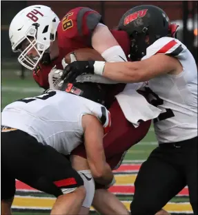  ?? RANDY MEYERS — FOR THE MORNING JOURNAL ?? Brandon Davies of Oberlin is stopped a pair of Ohio Wesleyan after making a catch during the first quarter Sept. 11.