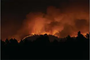  ?? LORENA SOPENA - VIA THE ASSOCIATED PRESS ?? A forest fire burns in the hills near Villanueva de Viver, Spain, in the early hours of Friday. It marked an early start to the nation’s fire season.