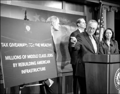  ?? AL DRAGO / THE NEW YORK TIMES ?? Senate Minority Leader Chuck Schumer, D-N.Y., speaks alongside fellow Democratic senators March 7 during a news conference on infrastruc­ture policy.