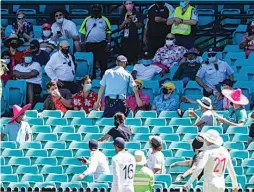  ?? — AP ?? Policemen talk to spectators as the game is stopped after a complaint by Indian players during play on day four of the third Test between India and Australia at the Sydney Cricket Ground on Sunday.