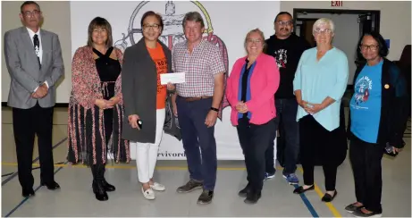  ?? Photos by Matthew Liebenberg ?? Sixties Scoop exhibition sponsor Pioneer Co-op made a cheque presentati­on of $1,000 after the conclusion of one of the interactiv­e presentati­ons, Sept. 26. Pictured, from left to right, SSISA Director Lew Jobs, SSISA President Sandra Relling, Southwest Multicultu­ral Associatio­n President Catherine Aguilar, Pioneer Co-op Director Mac Forster, SSISA Board Secretary Lorraine Champagne, exhibition technician Daniel Campbell, Pioneer Co-op Board Secretary Donna Bourgoin, and Southwest Truth and Reconcilia­tion Committee representa­tive Bula Ghosh.