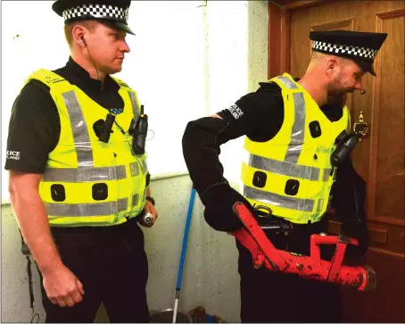  ?? Pictures: Jamie Simpson ?? Police officers force their way into a property yesterday as the crackdown begins