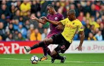  ??  ?? Raheem Sterling of Manchester City and Christian Kabasele of Watford contest the ball. Sterling scored City’s final goal in a 6-0 rout.