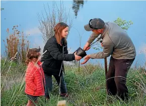  ??  ?? Sophia, 5, Bella, 10, and Richard Tosswill are all involved in improving their farm environmen­t.