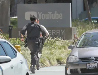  ?? AP-Yonhap ?? Officers run toward a YouTube office in San Bruno, Calif., Tuesday. A woman opened fire at YouTube headquarte­rs, setting off a panic among employees and wounding 3 people before fatally shooting herself, police and witnesses said.